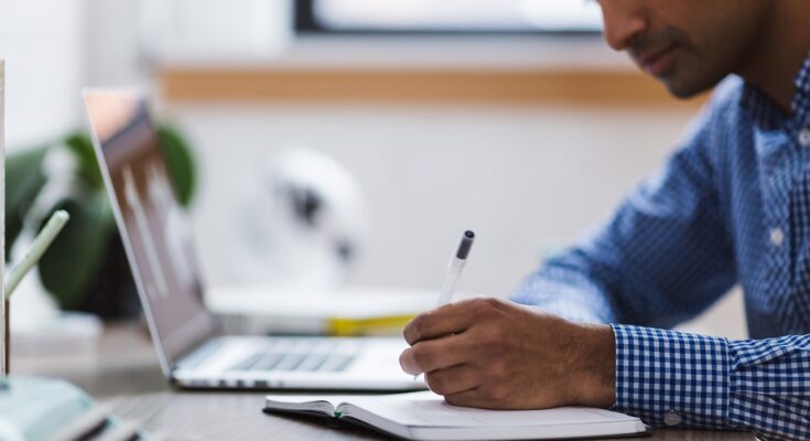 man, writing, laptop