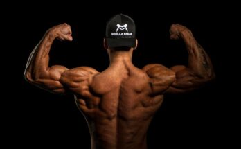 topless man wearing black and white cap